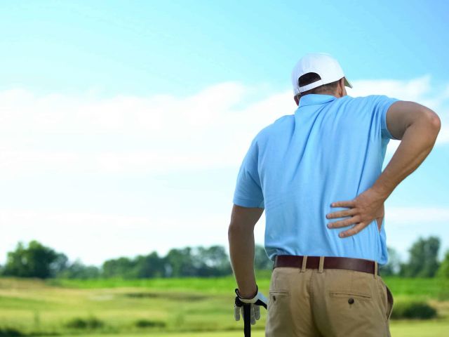 Male golf player feeling strong lower back pain after ball hitti