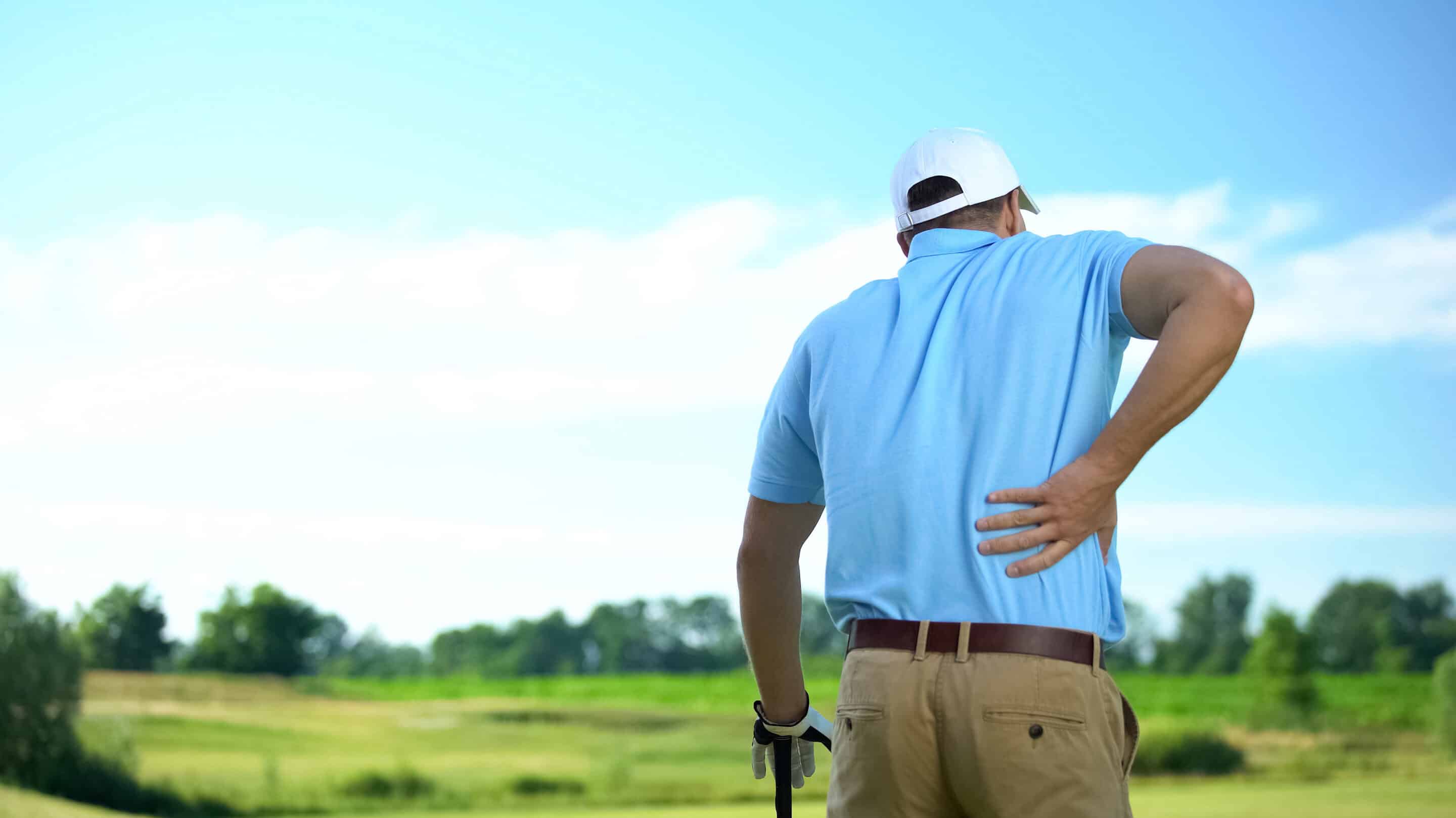 Male golf player feeling strong lower back pain after ball hitti