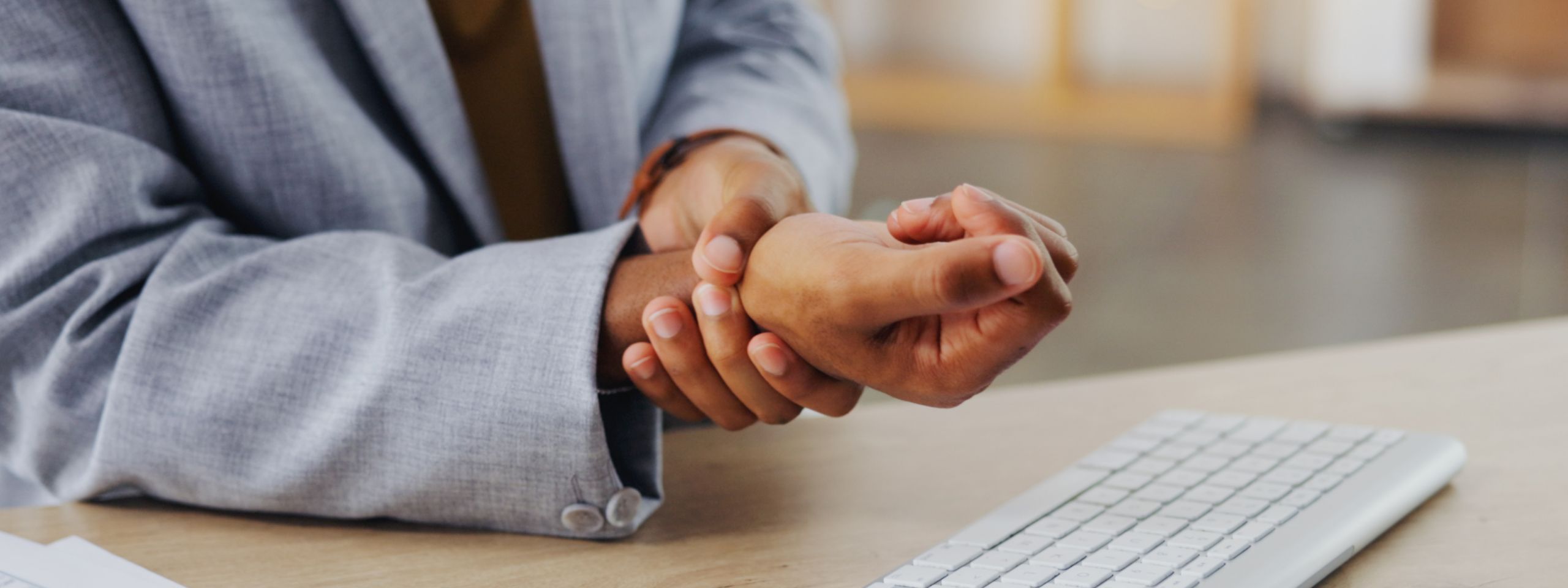 Hands of business man with problem, carpal tunnel syndrome or sore wrist from keyboard typing, office work or corporate project. Arthritis risk, medical crisis and hurt male worker with injury pain