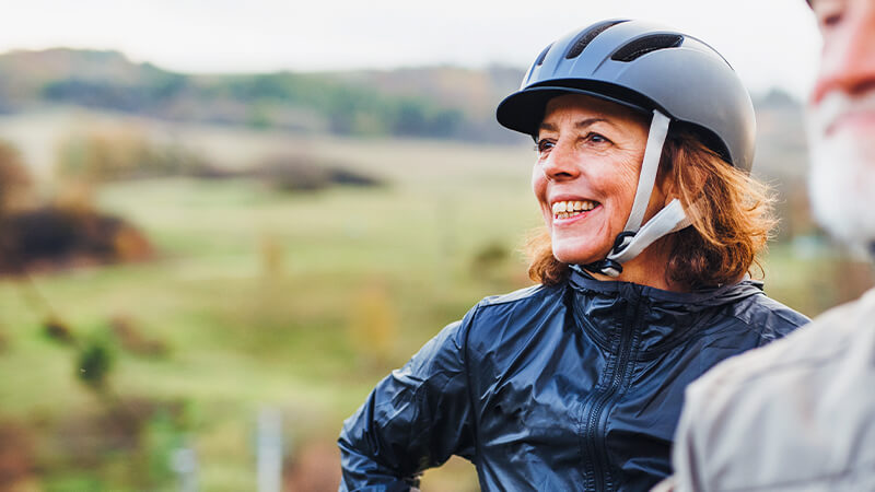 joint-preservation-testimonial-denise Joint preservation program testimonial. Woman smiling during bike ride